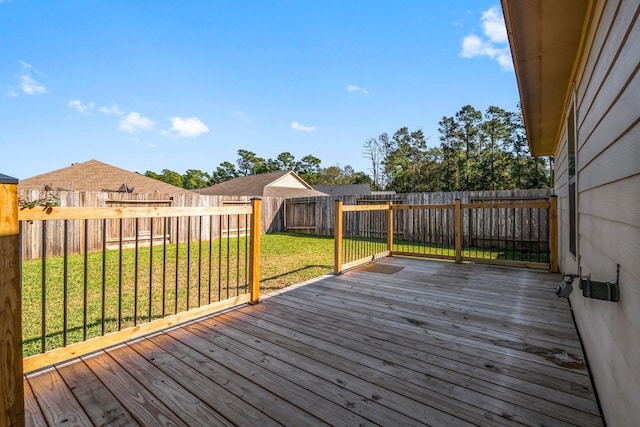 wooden deck featuring a yard