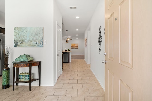 corridor featuring light tile patterned floors