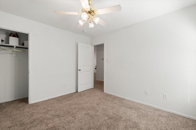 unfurnished bedroom featuring carpet, ceiling fan, and a closet