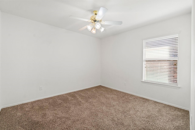 carpeted spare room featuring ceiling fan