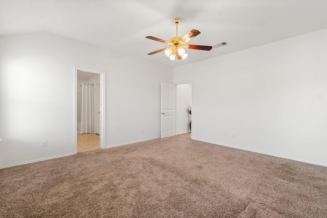 carpeted spare room with vaulted ceiling and ceiling fan