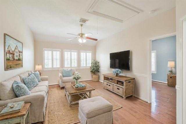 living room with light hardwood / wood-style flooring, ceiling fan, and lofted ceiling