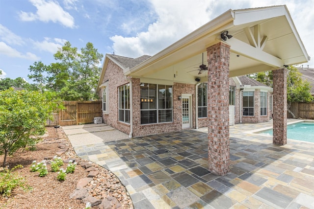 exterior space with a fenced in pool and ceiling fan