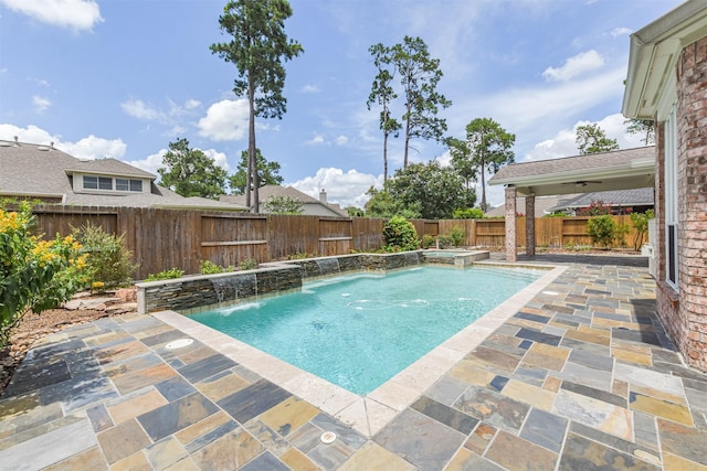 view of pool with pool water feature, ceiling fan, and a patio area