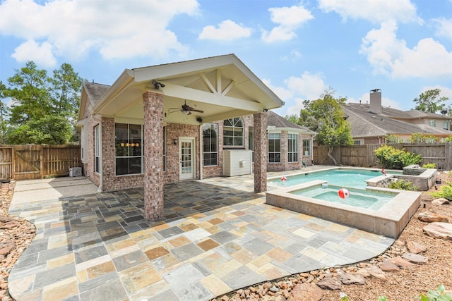 view of pool with an in ground hot tub, a patio, and ceiling fan