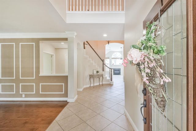 entryway featuring tile patterned floors and crown molding