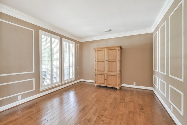 unfurnished room featuring light wood-type flooring and crown molding