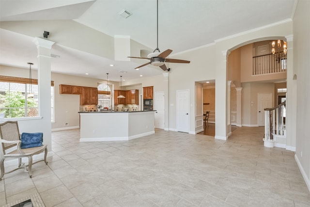 kitchen featuring high vaulted ceiling, ceiling fan with notable chandelier, black microwave, and hanging light fixtures