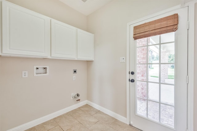 clothes washing area featuring washer hookup, electric dryer hookup, cabinets, and light tile patterned floors