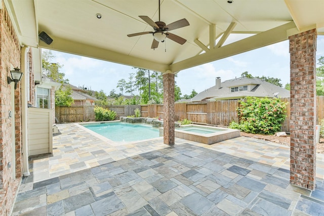 view of pool featuring an in ground hot tub, pool water feature, a patio, and ceiling fan