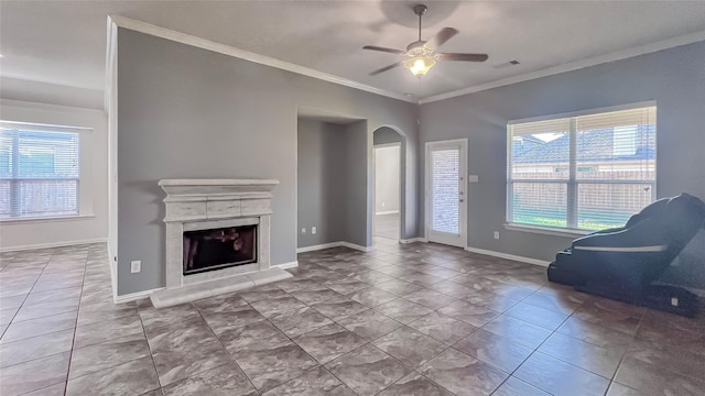 unfurnished living room featuring light tile patterned floors, ceiling fan, and crown molding