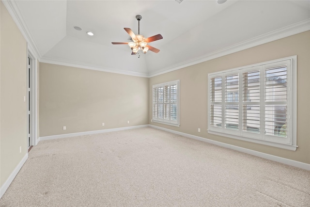 carpeted empty room with lofted ceiling and crown molding