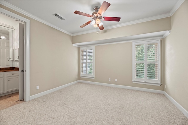 carpeted empty room featuring ceiling fan and ornamental molding