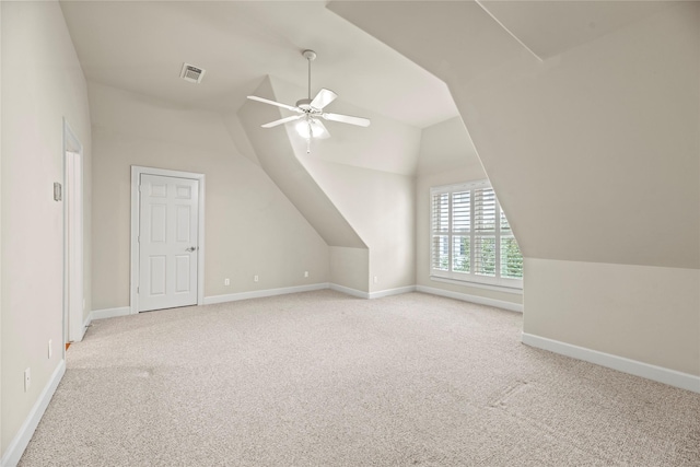 additional living space featuring ceiling fan, light carpet, and vaulted ceiling