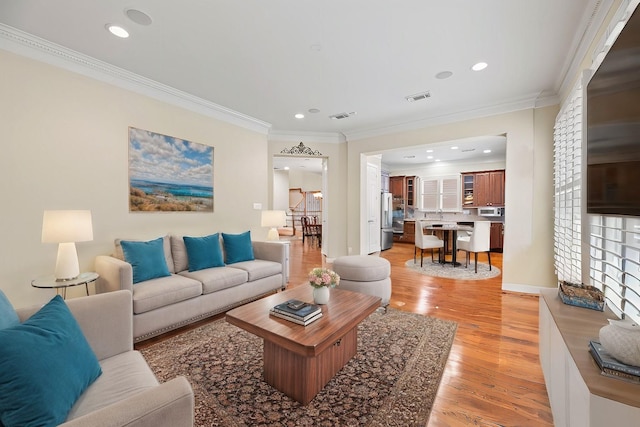 living room featuring light hardwood / wood-style floors and ornamental molding