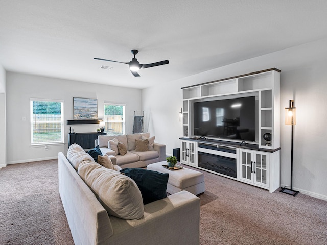 carpeted living room featuring ceiling fan