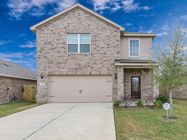 view of property with a front yard and a garage