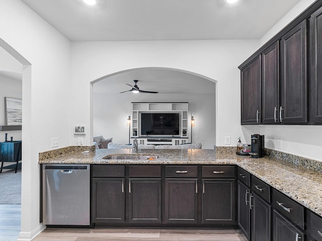 kitchen featuring sink, stainless steel dishwasher, light stone counters, and ceiling fan