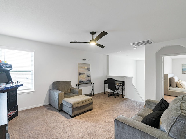 carpeted living room featuring ceiling fan