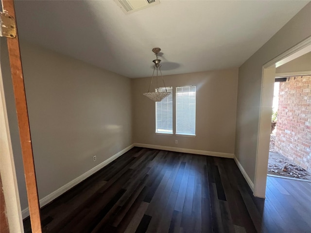 unfurnished dining area with dark hardwood / wood-style floors and a notable chandelier