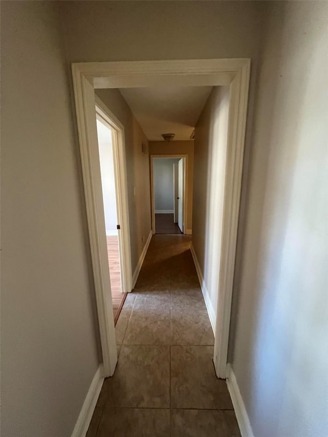 hallway featuring tile patterned flooring