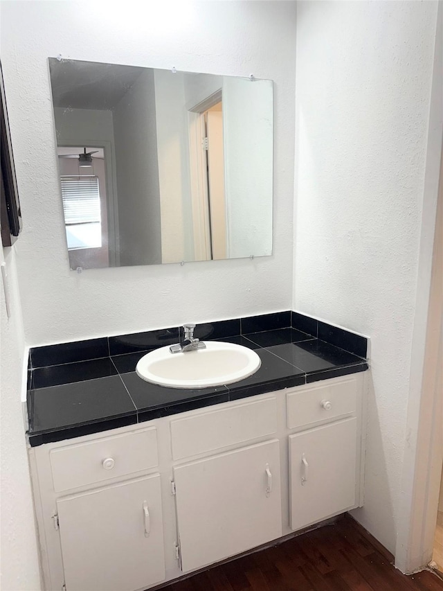 bathroom featuring hardwood / wood-style flooring and vanity