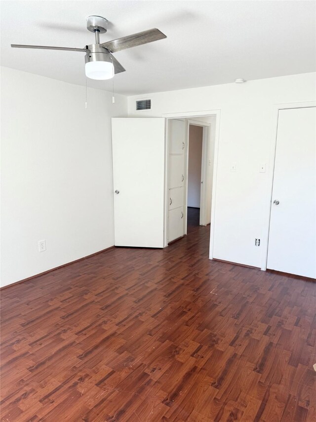 unfurnished bedroom featuring dark hardwood / wood-style floors and ceiling fan