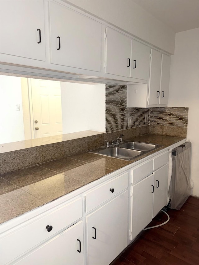 kitchen with decorative backsplash, sink, dishwasher, white cabinets, and dark hardwood / wood-style floors