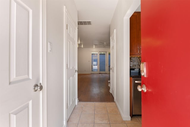 hall with light tile patterned floors