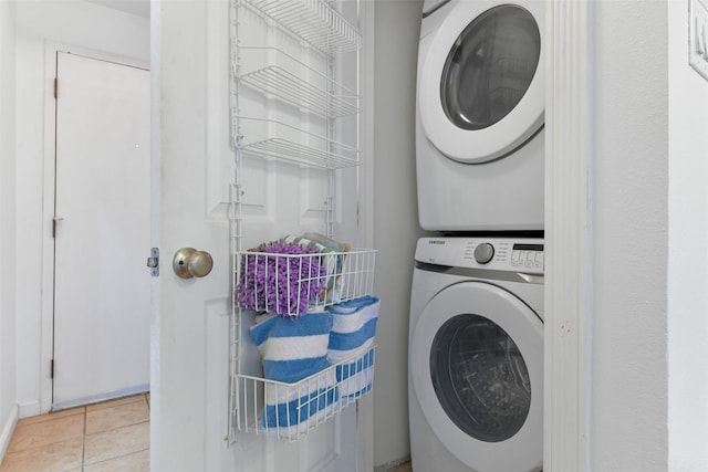 washroom featuring light tile patterned floors and stacked washer / drying machine