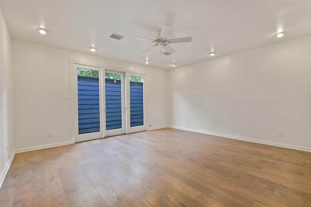 empty room with ceiling fan and hardwood / wood-style floors