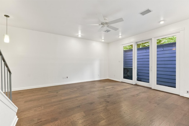 spare room with dark hardwood / wood-style floors and ceiling fan