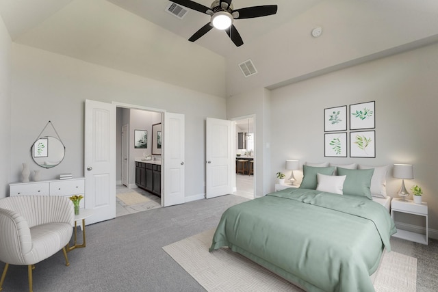 bedroom with ensuite bathroom, ceiling fan, light colored carpet, and high vaulted ceiling