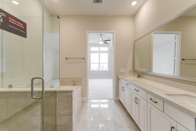 bathroom with a bath, vanity, and ceiling fan