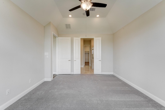 carpeted spare room with ceiling fan and lofted ceiling