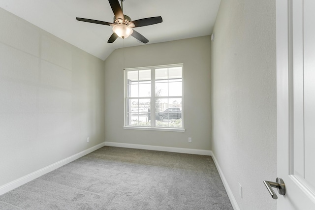 carpeted spare room with ceiling fan and baseboards