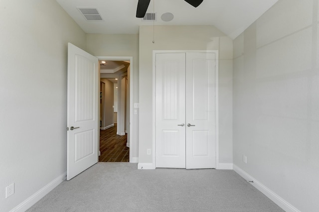 unfurnished bedroom featuring a closet, visible vents, baseboards, and carpet flooring