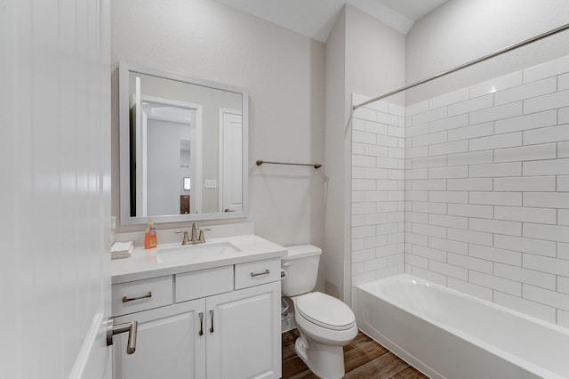 bathroom with shower / bathing tub combination, vanity, toilet, and wood finished floors