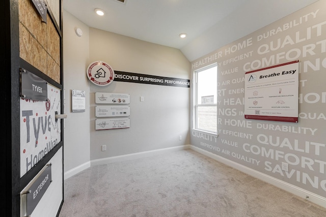 carpeted empty room with baseboards, vaulted ceiling, and recessed lighting