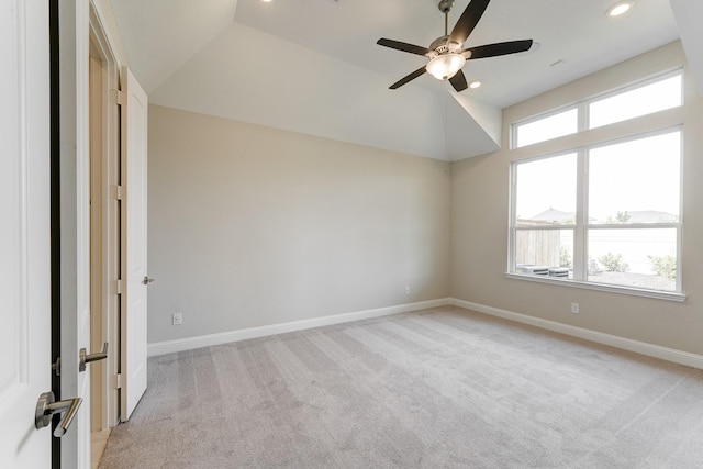 spare room featuring recessed lighting, a ceiling fan, light carpet, vaulted ceiling, and baseboards