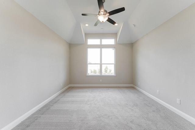 empty room featuring ceiling fan, light colored carpet, and baseboards