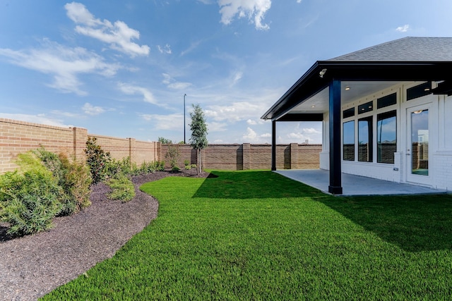 view of yard featuring a patio area and a fenced backyard