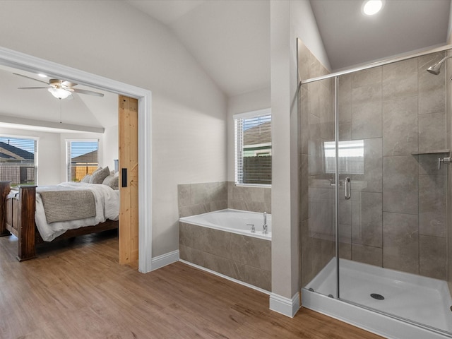 bathroom featuring hardwood / wood-style floors, independent shower and bath, ceiling fan, and lofted ceiling