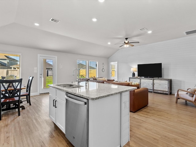 kitchen with dishwasher, white cabinets, a center island with sink, sink, and light wood-type flooring