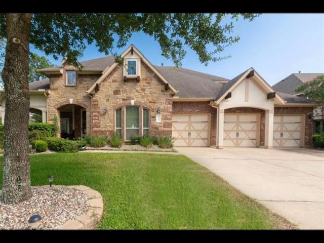 view of front of house with a front lawn and a garage