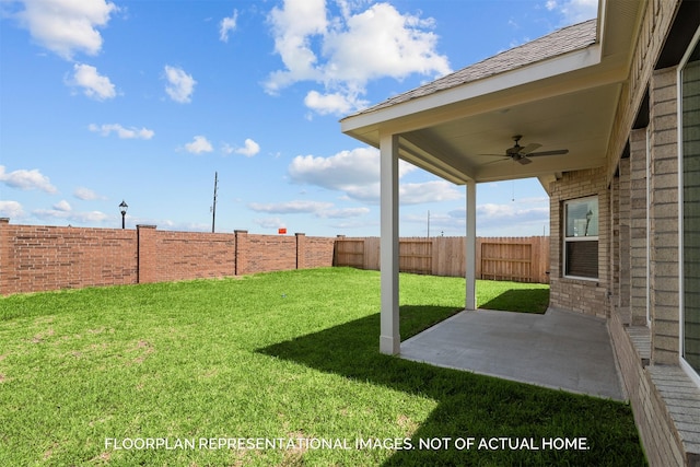 view of yard with ceiling fan and a patio area