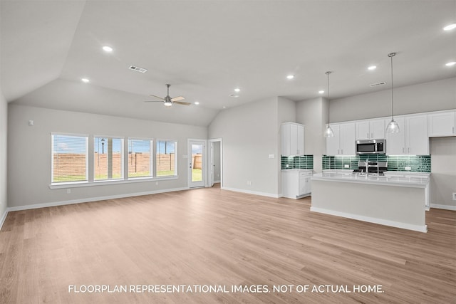 unfurnished living room with ceiling fan, light hardwood / wood-style flooring, and vaulted ceiling