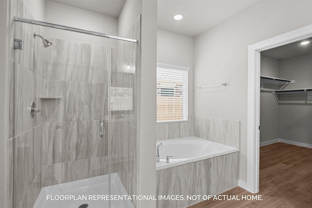 bathroom with hardwood / wood-style flooring and plus walk in shower