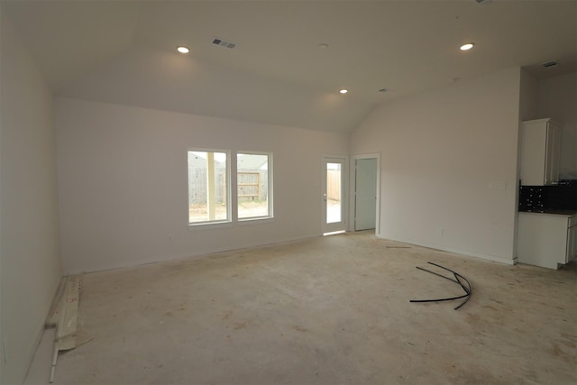 unfurnished living room with recessed lighting, visible vents, and high vaulted ceiling