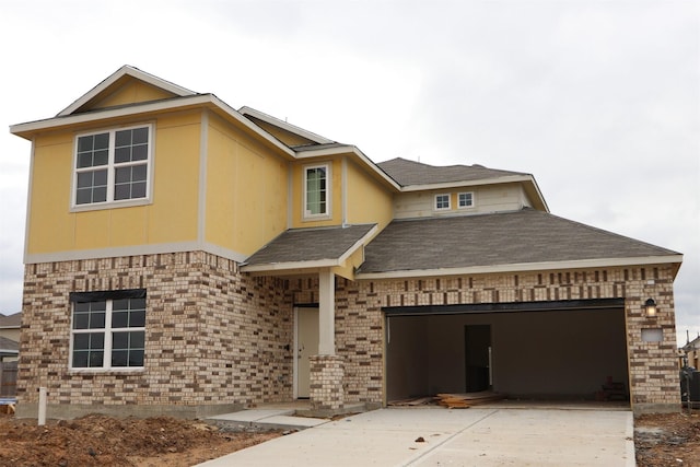 view of front facade with concrete driveway, an attached garage, brick siding, and a shingled roof